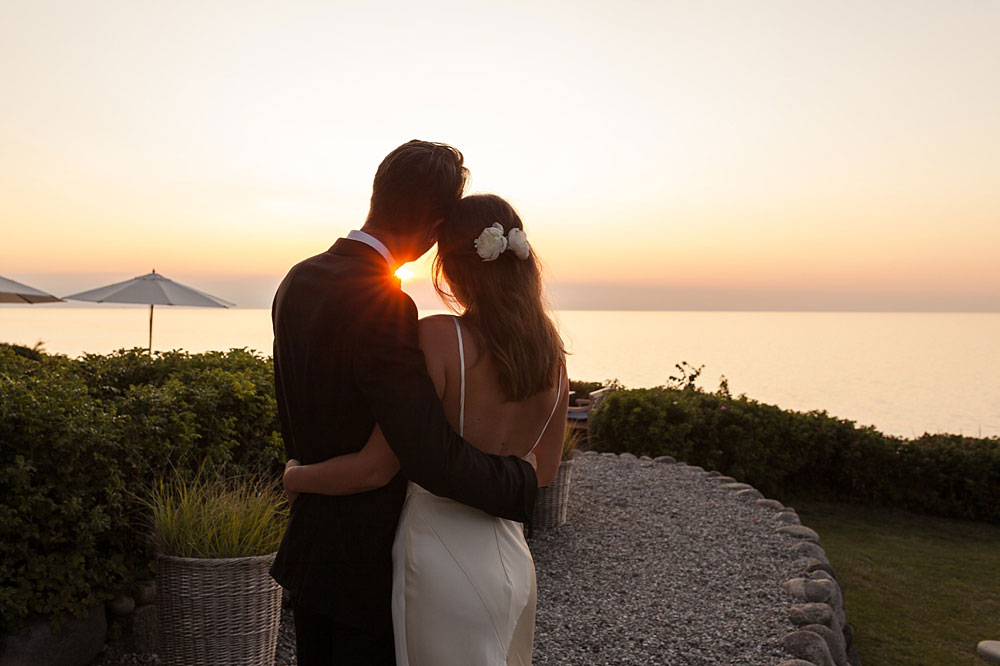 bride and groom watching the sunset at Helenekilde Badehotel in Tisvildeleje