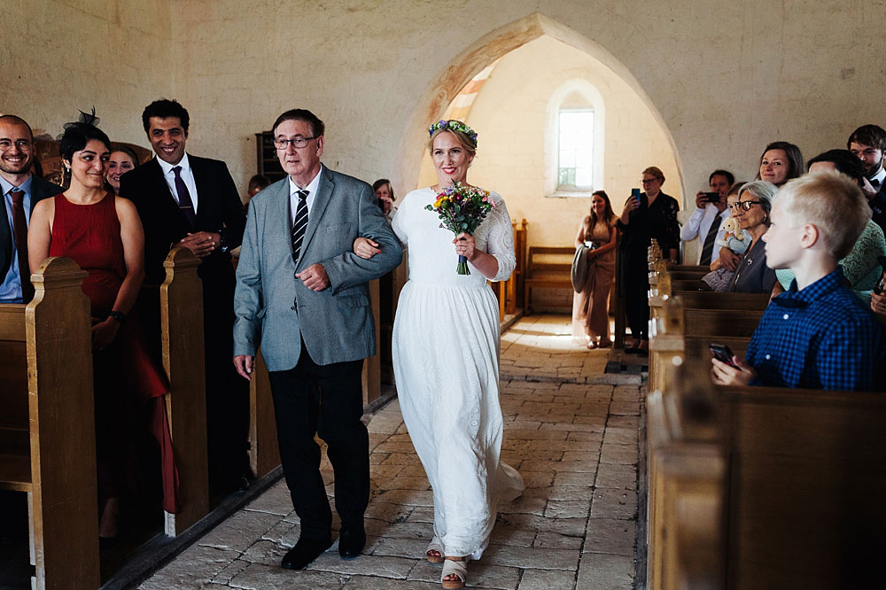 father of the bride walking the bride down the aisle in Stevns Klint