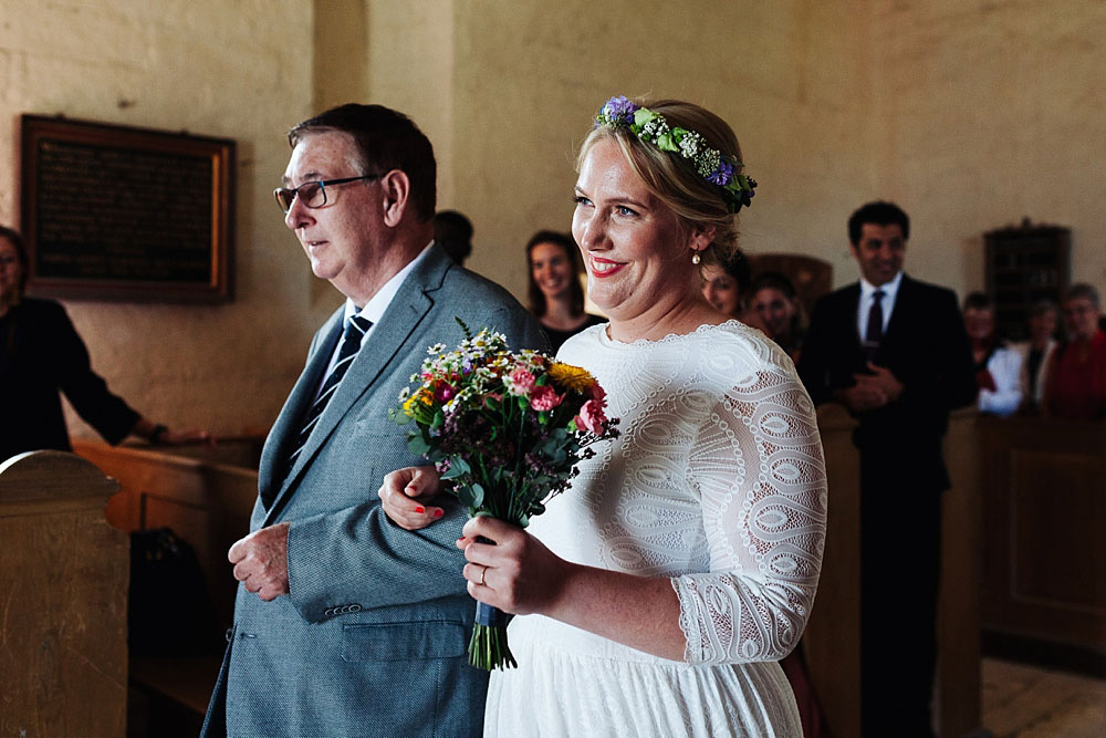 father of the bride walking the bride down the aisle in Stevns Klint