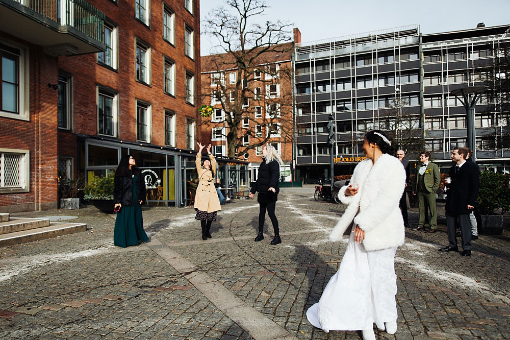 bride throwing the bouquet at Frederksberg Town Hall