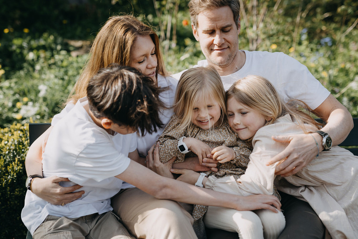 Family portrait in Copenhagen: A happy family of five posing together in Frederiksberg Have