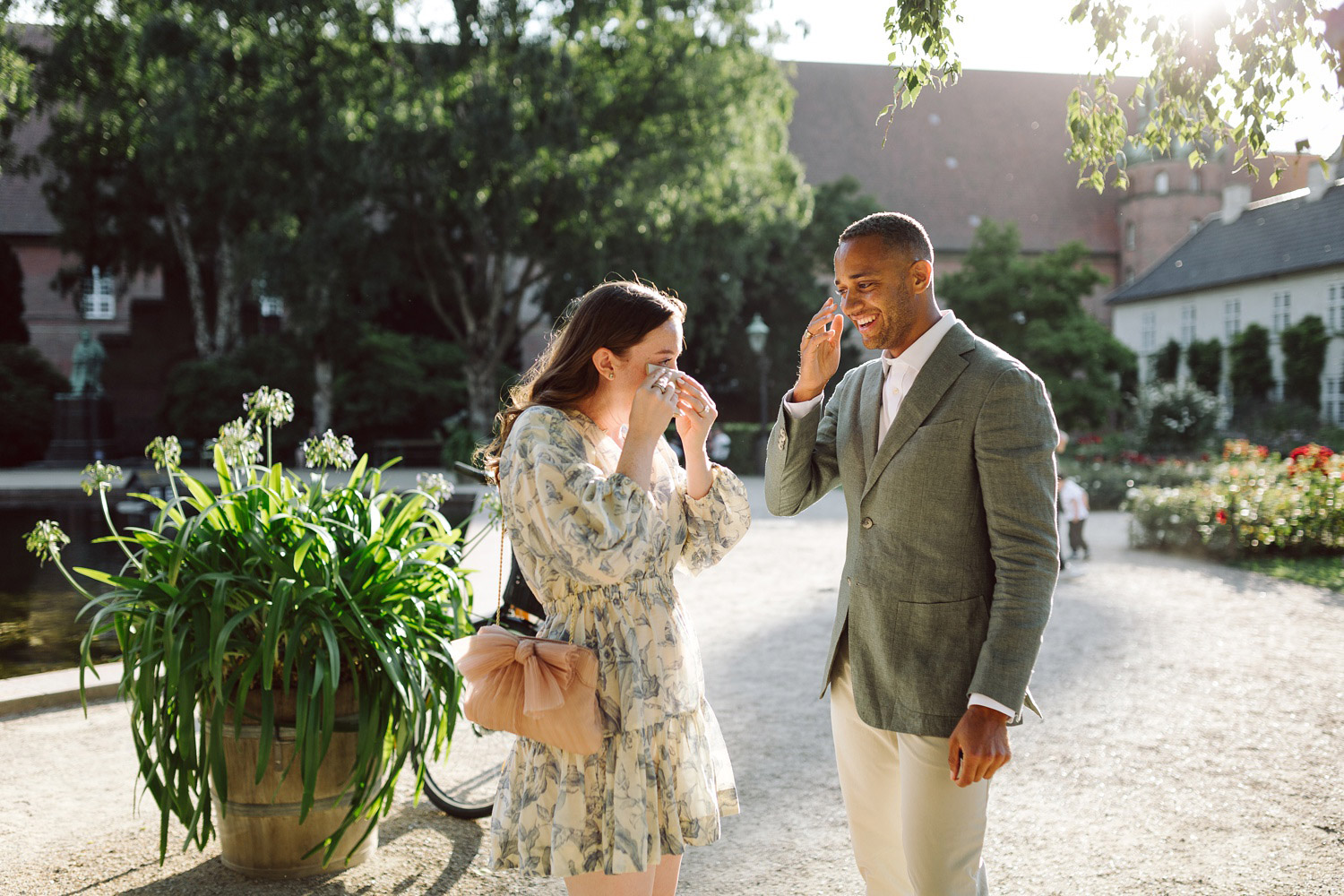 Happy couple celebrating their engagement at the Royal Library Garden in Copenhagen.