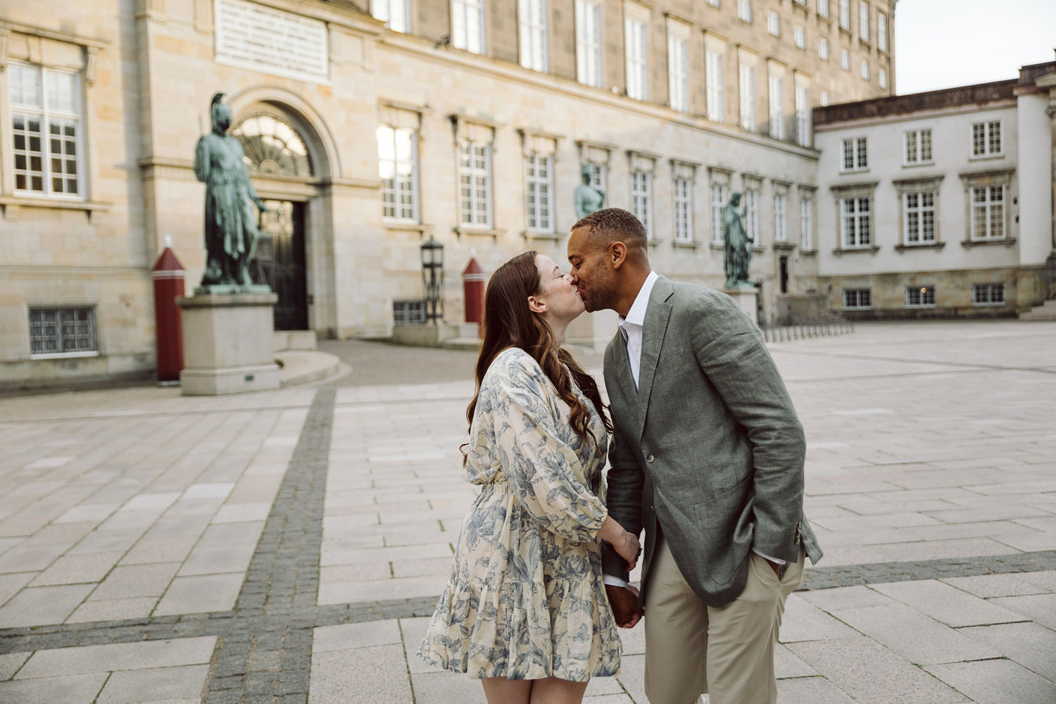 Couple sharing a kiss after saying yes during a golden hour proposal in Copenhagen